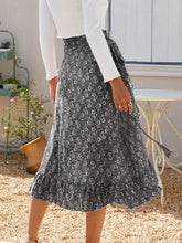 Back view of Faylora Drift Skirt in black showing cascading ruffled hem and relaxed fit