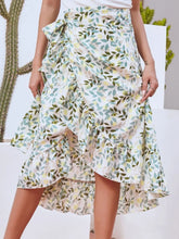 Faylora Drift Skirt front view in gum leaf botanical print with side tie waist and asymmetric ruffled hem