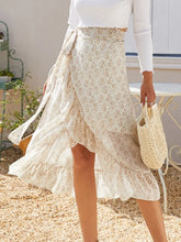 Side view of Faylora Drift Skirt pastel yellow highlighting low-high side ruffles and floral print