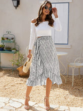 Full body styled look featuring Faylora Drift Skirt in gray paired with white off-shoulder top, sunglasses, straw handbag, and tan heels