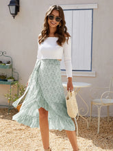 Full body styled look featuring Faylora Drift Skirt in green paired with white off-shoulder top, sunglasses, and straw hand bag
