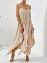 Model posing in the Fleur De Flow Luxe scoop neck cami dress in tan at a photography studios.