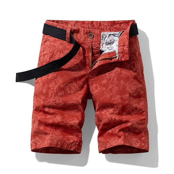 Front view of red Florvado TerrainFlex Bermuda Shorts with floral pattern.