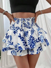 Front view of Floryza Bloom Layer Ruffle Shorts in blue floral pattern.