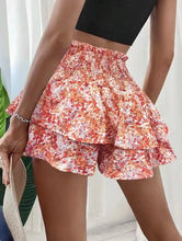 Back view of orange Floryza shorts showing layered skirt-like shape.