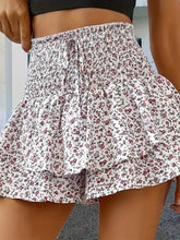 Front view of white floral Floryza BloomLayer Ruffle Shorts.