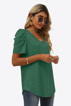 Side angle of forest green V-neck puff sleeve tee featuring gathered sleeve detail and casual, easy side fit.
