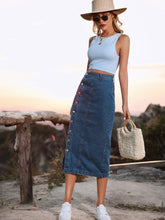 French blue Denivéra Button Skirt styled with blue tank, sunglasses, brim hat, and sneakers