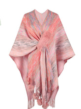 Front view of carnation pink Heathered Fringe Hem Poncho laid flat, displaying heathered knit texture, multicolor contrast, and pom pom fringe detail along the hem.