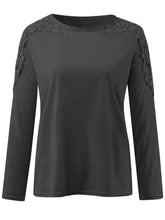 Front view of black FloraFrost™ Tee highlighting lace floral cutout shoulders and round neckline.
