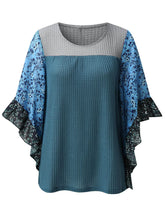 Front view of the BlossomEase Blouse in dusty blue to show floral sleeves and ruffle trim.