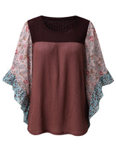 Front view of the BlossomEase Blouse in dusty pink to show floral sleeves and ruffle trim.