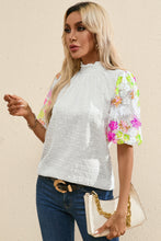 Front view of LustruBloom™ Blouse showcasing sequin floral half sleeves and ruched mock neckline.