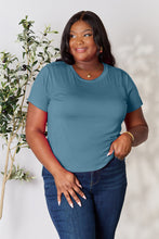 Model smiling in vibrant dusty blue solid short sleeve t-shirt