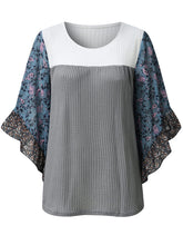 Front view of the BlossomEase Blouse in gray to show floral sleeves and ruffle trim.