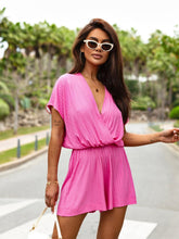 Model in fuchsia pink romper styled with white sneakers and hoop earrings in a park setting—vibrant, playful, and perfect for festivals or casual brunches.