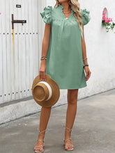 Full body image of woman modeling the Calivémuse™ Sage Ruffled Notched Cap Sleeve Mini Dress styled with a straw hat, jewelry, and strappy flat sandals.