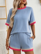 Close-up on neckline and contrast trim of Glowthentic™ Light Blue set.