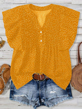 Front view of EverDot Flutter Top in gold polka dot with flutter sleeves paired with earrings, belt, brown sandals, and straw handbag in a flat lay photo.