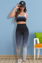 Model in black Gradient Flow Momentum set, front view showing ombré tank and high-waist leggings.