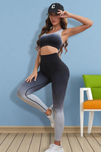 Model in black Gradient Flow Momentum set performing yoga stretch.