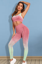 Model in strawberry Gradient Flow Momentum set performing yoga stretch.