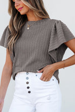 Model styled in a gray RuffleRidge™ Top with accessories for a complete look.