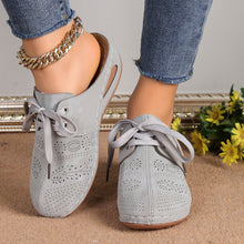 Front view of grey Lace-Up Round Toe Wedge Sandals and a gold anklet and blue jeans.