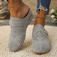 Model showcasing the front a pair of grey Suede Round Toe Wedge Sandals with two golden anklets and ripped blue jeans highlighting perforation detail.