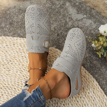Model showcasing the front a pair of grey Suede Round Toe Wedge Sandals with two golden anklets and ripped blue jeans.