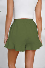 Rear angle of green shorts showing breezy cotton fit.