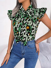 Close-up of green leopard print fabric showing the silky finish and intricate pattern with soft, breathable texture.