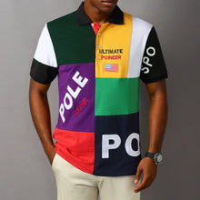 Model wearing RegaliaSport Elite Green Multi-Color Embroidered Polo showcasing relaxed fit and bold multi-color design.