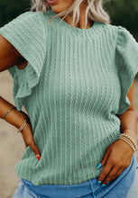 Model styled in a gum leaf RuffleRidge™ Top with accessories for a complete look.