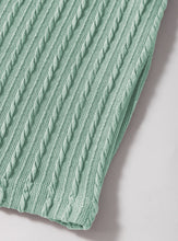 A close up photo of the fabric quality and ribbed rope texture of a gumleaf Round Neck Flounce Sleeve Blouse.
