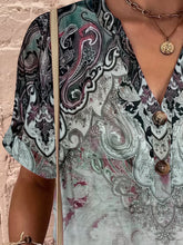Close-up of half button-up and button  detail on dark green Printed Short Sleeve Blouse.