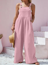 Close-up of dusty pink overalls' texture and functional pockets detail.