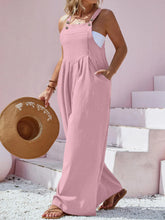 Plus size model wearing dusty pink Harmonique wide-leg overalls with a fitted white tee.