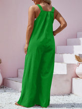 Back view of plus size model in green Harmonique overalls showing adjustable straps and premium fabric texture.