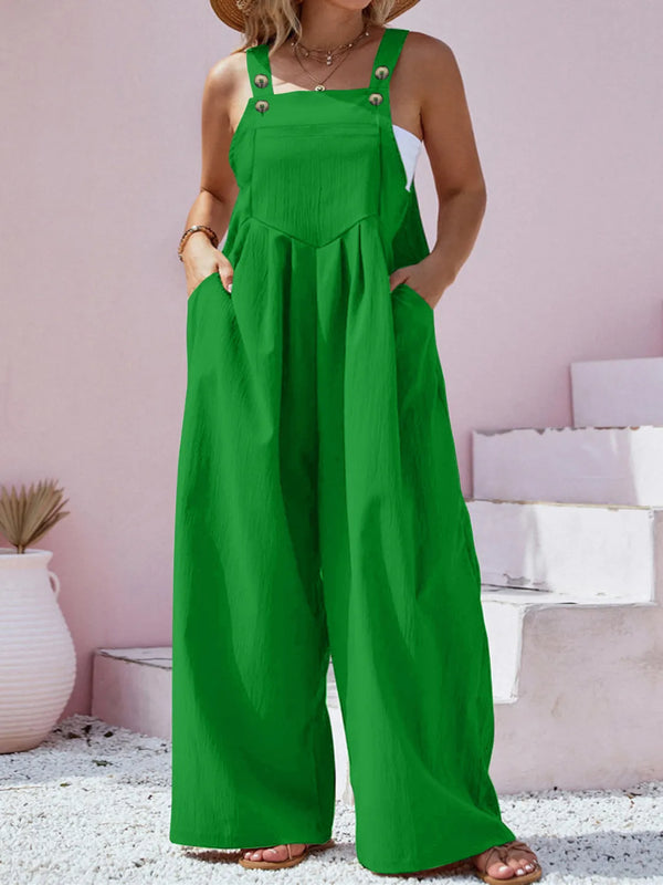 Model wearing green Harmonique Wide-Leg Overalls, paired with a white blouse and sneakers, perfect for a casual day out.