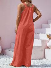 Back view of orange Harmonique wide-leg overalls with adjustable straps.
