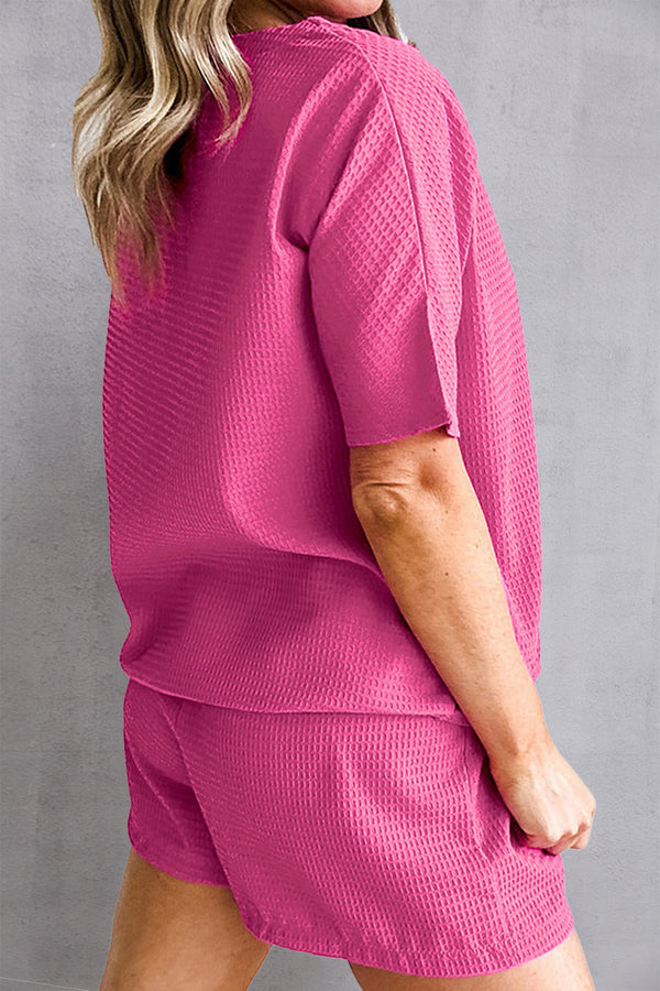 Back view of Healed & Waffled Up Lounge Set in hot pink, showcasing textured fabric and relaxed shorts fit.