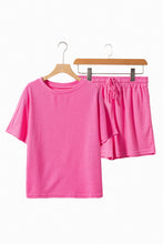Healed & Waffled Up Lounge Set in hot pink, front view on a hanger showcasing waffle-knit texture, round neck top, and matching drawstring shorts.