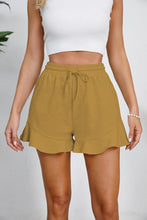 Model wearing honey-colored Plus Size Drawstring Ruffle Hem Shorts, showcasing rich, warm tone and tie waist.
