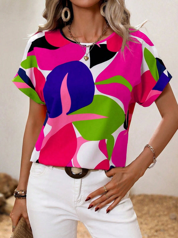 Model wearing a hot pink contrast round neck short sleeve blouse, paired with light-wash jeans and subtle jewelry for a fresh, casual daytime look.