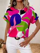 Model wearing a hot pink contrast round neck short sleeve blouse, paired with light-wash jeans and subtle jewelry for a fresh, casual daytime look.