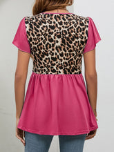 Back view of hot pink leopard print babydoll blouse showcasing flutter sleeves, rounded neckline, and relaxed gathered silhouette.