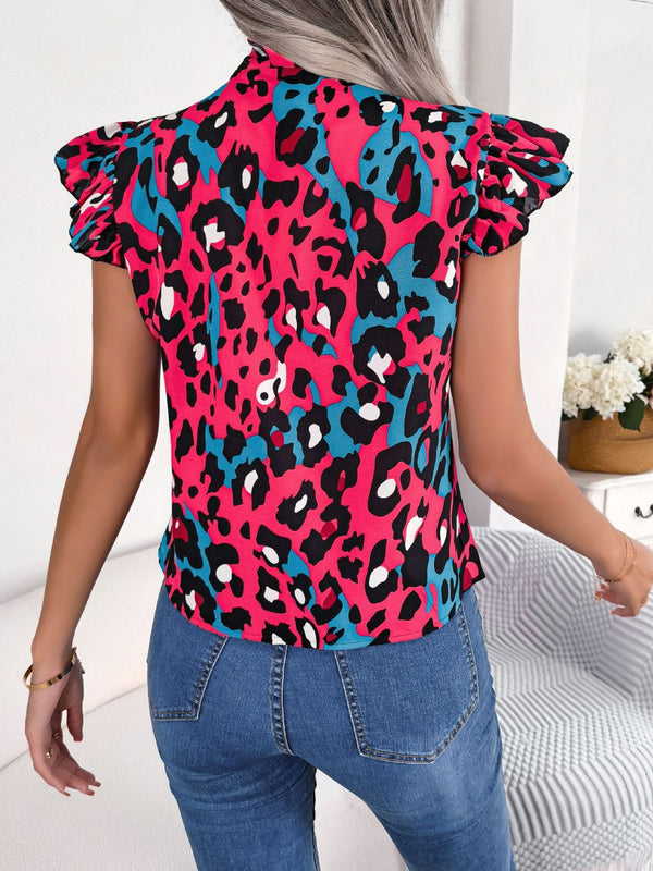 Back view of hot pink leopard print cap sleeve blouse showing lightweight fabric and subtle drape with tie-neck detail visible at the back.