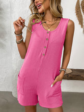 Model in hot pink romper standing confidently, showing bold color and front button detail—high-energy and striking.