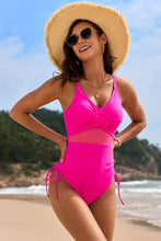 Hot pink drawstring ruched V-neck one-piece swimwear front view styled with straw hat